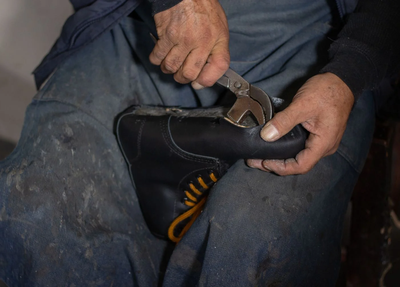 Cobbler hammering a sole onto a leather shoe